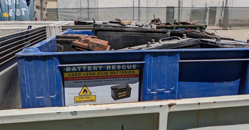 Photo of a Plastic Battery Bin showing the common problem of batteries protruding above the height of the bin's side and thus being unable to secure the lid.